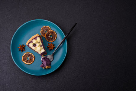 No baked sweet blueberry cheesecake with cream cheese on a dark texture backgroundの写真素材