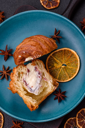 Sweet craffin made from puff pastry with Swiss meringue on a dark textured backgroundの写真素材