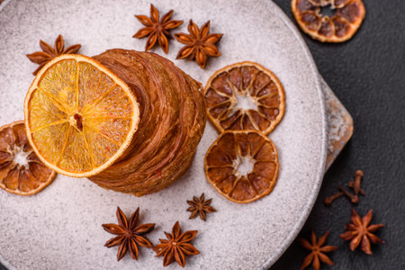 Sweet craffin made from puff pastry with Swiss meringue on a dark textured backgroundの写真素材