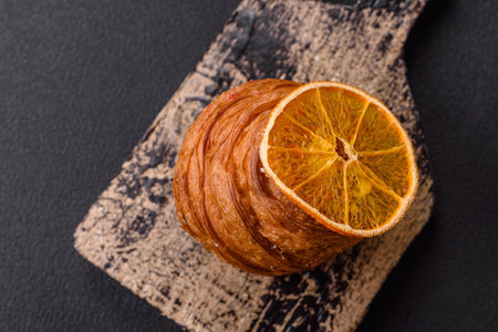 Sweet craffin made from puff pastry with Swiss meringue on a dark textured background
