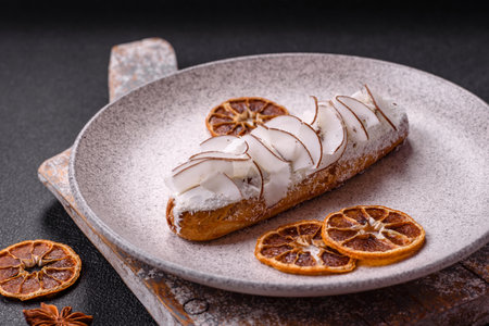 Sweet eclair with coconut slices on a dark concrete background