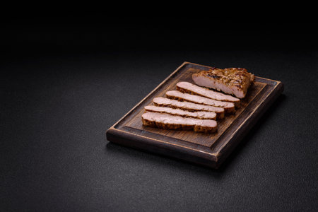 Grilled beef steak with salt, spices and herbs on a dark backgroundの写真素材