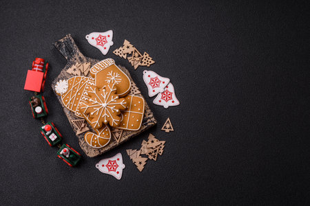 Homemade Christmas gingerbread cookies made as sweets and holiday table decorations
