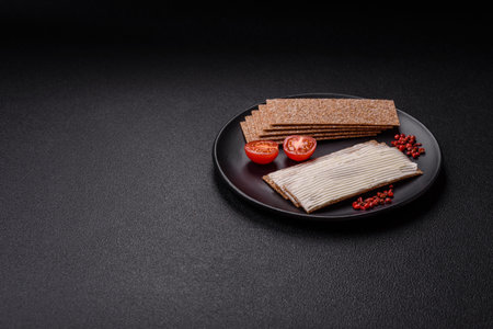 Rectangular whole grain crisp bread with cream cheese for a hearty, nutritious breakfastの写真素材