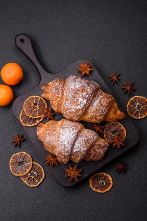 Fresh crispy sweet croissant with chocolate filling as part of a hearty breakfastの写真素材
