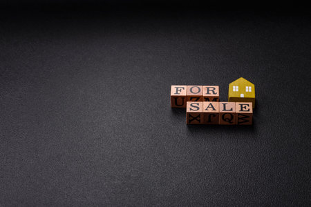 The inscription for sale laid out with wooden cubes as a concept for selling real estateの写真素材