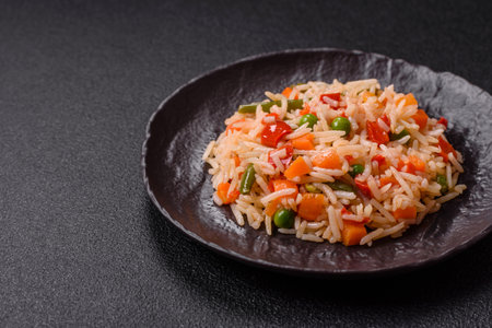 Boiled rice with vegetables, salt and spices on a dark concrete backgroundの写真素材