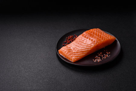 Fresh raw salmon steak with spices and herbs prepared for grilled baking. Healthy seafood food