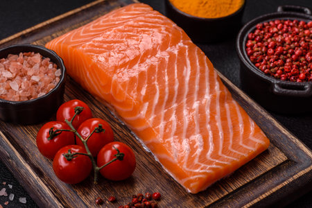 Fresh raw salmon steak with spices and herbs prepared for grilled baking. Healthy seafood foodの写真素材
