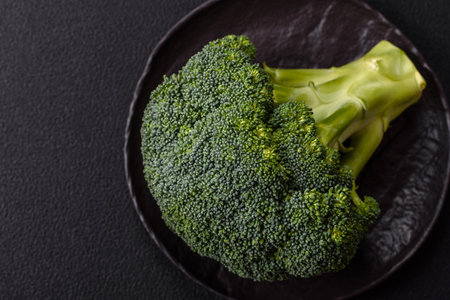 A sprig of raw green broccoli as an ingredient for a healthy vegetarian or vegan mealの写真素材