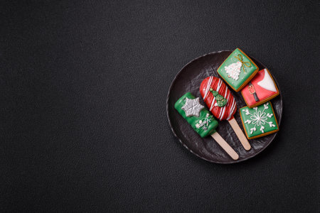 Natural popsicle ice cream on a stick covered with chocolate in the style and colors of Christmas and New Year on a dark concrete backgroundの写真素材