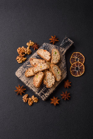 Freshly baked Italian cantuccini cookies with nuts and candied fruits on dark concrete backgroundの写真素材