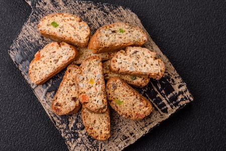 Freshly baked Italian cantuccini cookies with nuts and candied fruits on dark concrete backgroundの写真素材