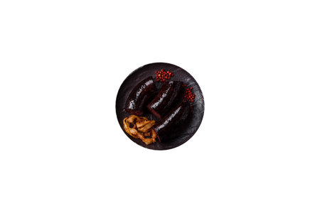 Delicious black blood sausage or black pudding with spices and herbs grilled on a white background