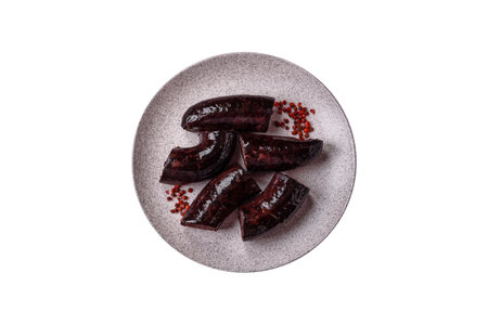 Delicious black blood sausage or black pudding with spices and herbs grilled on a white backgroundの写真素材