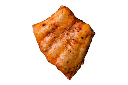 Grilled fish fillet with salt, spices and herbs on a white background