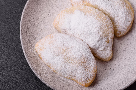 Sweet dumplings sprinkled with powdered sugar on dark concrete backgroundの写真素材