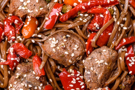 Delicious spicy Asian food soba with buckwheat noodles, beef, vegetables, salt and spices