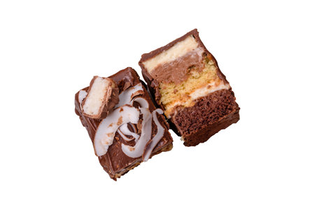Piece of sweet chocolate cake with coconut flakes and sponge cake on white backgroundの写真素材