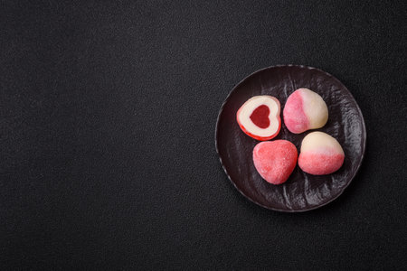 Delicious sweet mochi in the shape of red hearts for the holiday of Valentine's Dayの写真素材