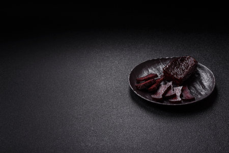 Meat with salt, spices and herbs on a dark concrete background