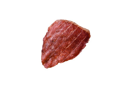 Dried pork meat slices with salt and spices on a white backgroundの写真素材