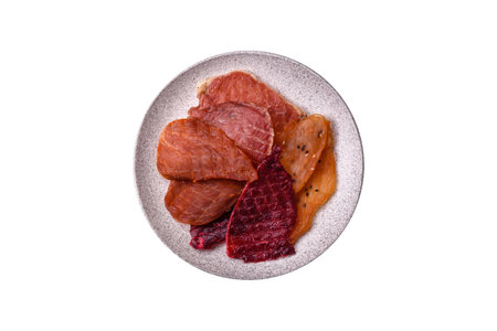 Jerky, dried pork meat with salt and spices on white backgroundの写真素材