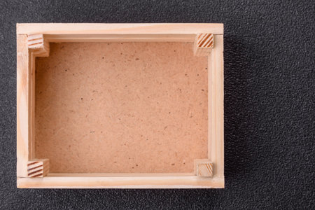 Empty wooden box on dark concrete background