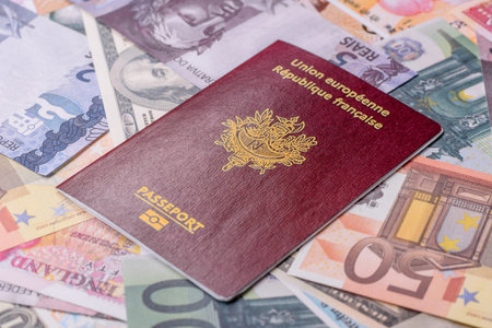 International passport of a citizen of France on background of paper banknotes of different...
