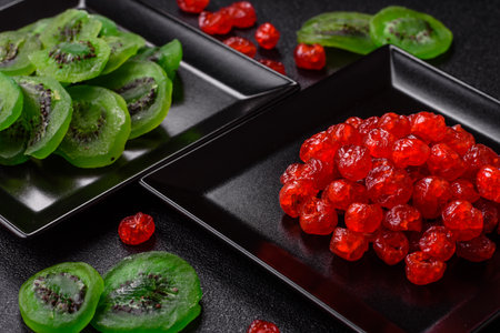 Dried sweet green kiwi or candied fruit on dark concrete background