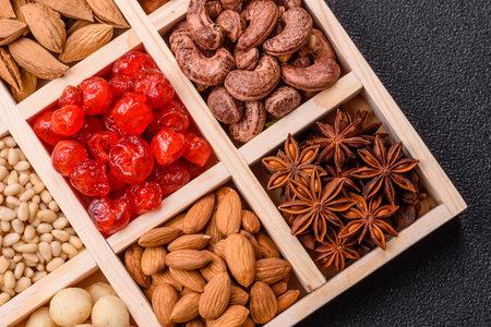 Mix of macadamia, cashew, hazelnut, peanut, pistachio nuts in a wooden box with several sections