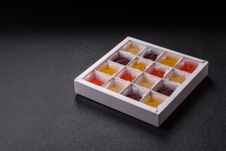 Jelly candies with different flavors on a dark background