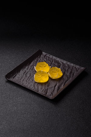 Jelly candies or homemade marmalade with different flavors on a dark concrete backgroundの写真素材