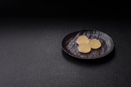 Jelly candies with different flavors on a dark concrete backgroundの写真素材