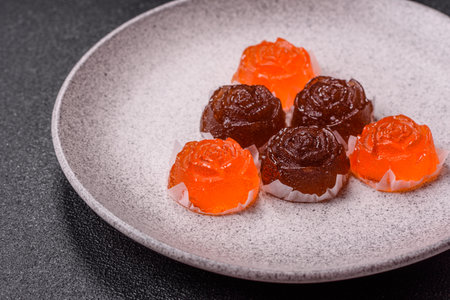 Jelly candies or homemade marmalade with different flavors on a dark concrete backgroundの写真素材