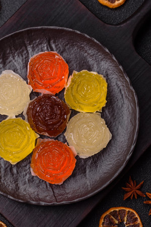 Jelly candies or homemade marmalade with different flavors on a dark concrete backgroundの写真素材