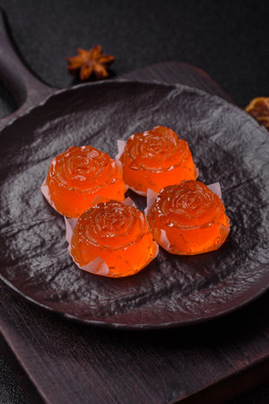 Jelly candies or homemade marmalade with different flavors on a dark concrete backgroundの写真素材