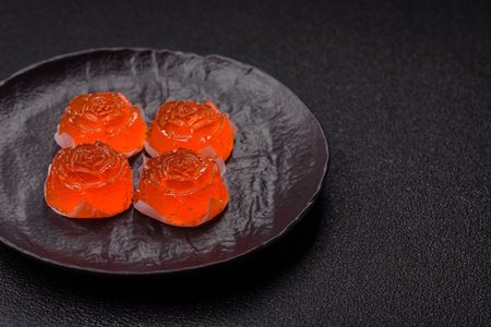 Jelly candies or homemade marmalade with different flavors on a dark concrete backgroundの写真素材