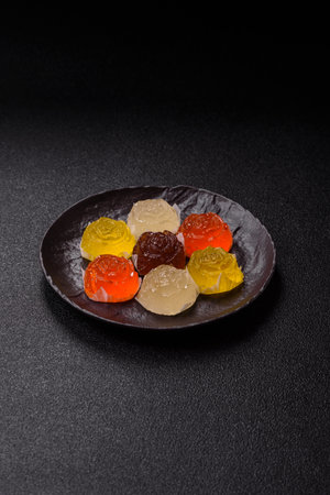 Jelly candies or homemade marmalade with different flavors on a dark concrete backgroundの写真素材