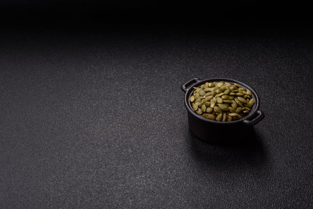 Peeled pumpkin seeds in a bowl, an ingredient for making vegan or vegetarian food. Tasty and healthy foodの写真素材