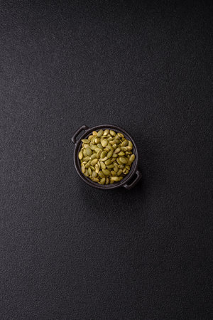 Peeled pumpkin seeds in a bowl, an ingredient for making vegan or vegetarian food. Tasty and healthy foodの写真素材