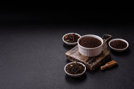 Black tea dry crushed in bowl on dark concrete backgroundの写真素材