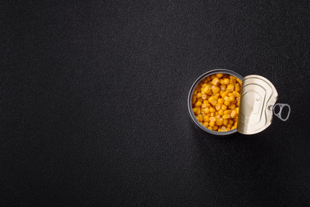 Sweet yellow canned corn in bowl on dark concrete backgroundの写真素材
