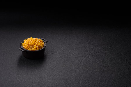 Sweet yellow corn in bowl on dark concrete backgroundの写真素材