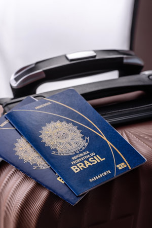 International passport of a citizen of Brazil on a suitcase, departure from the airport, international travelの写真素材