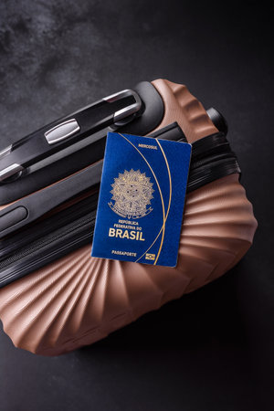 International passport of a citizen of Brazil on a suitcase, departure from the airport, international travelの写真素材