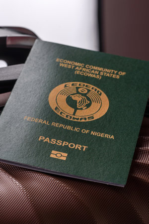 International passport of a citizen of Nigeria on a suitcase, departure from the airport, international travelの写真素材