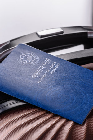 International passport of a citizen of South Korea on a suitcase, departure from the airport, international travelの写真素材