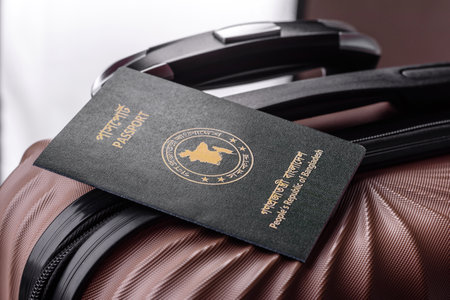 International passport of a citizen of Bangladesh on a suitcase, departure from the airport, international travelの写真素材