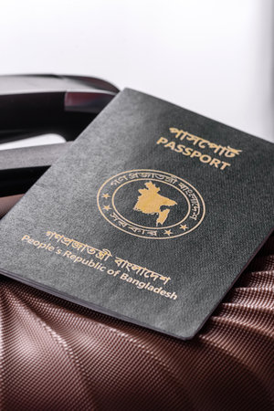 International passport of a citizen of Bangladesh on a suitcase, departure from the airport, international travelの写真素材